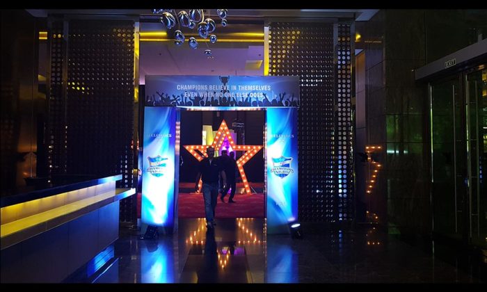 Lit red star entrance decorated with a banner reading "Champions believe in themselves, even when no one else does" under Vivo Champions Night branding.